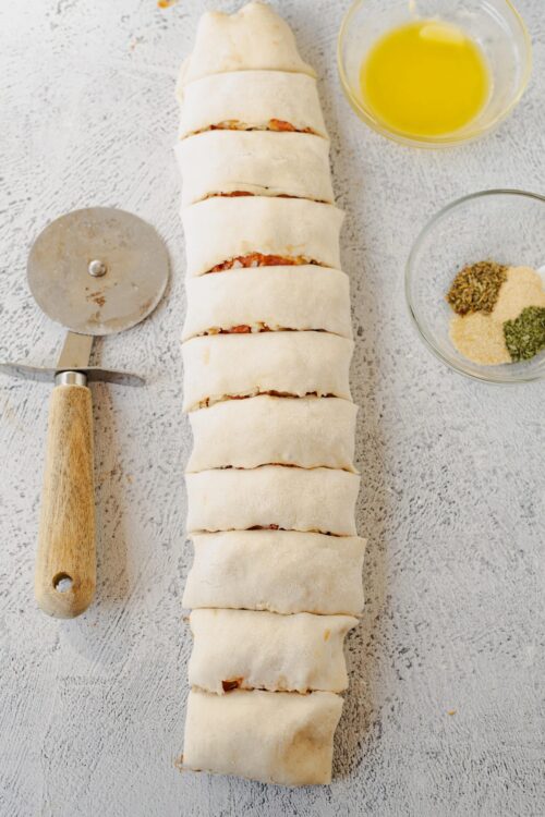 Fresh homemade stromboli dough stuffed with ingredients, ready to bake.