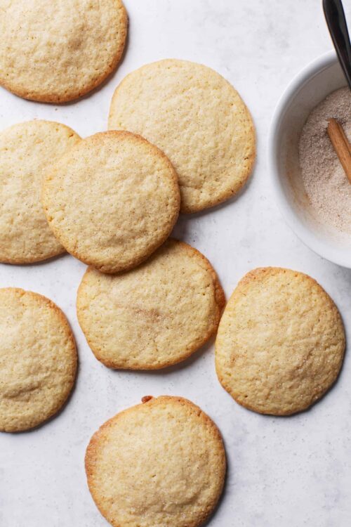 Butter cookies on white surface with sugar bowl and cinnamon stick, homemade cookies, baked goods, baking recipes, simple dessert, Baked Bree.