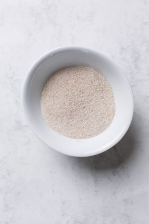 Fine pink Himalayan salt in a white bowl for baking and cooking.