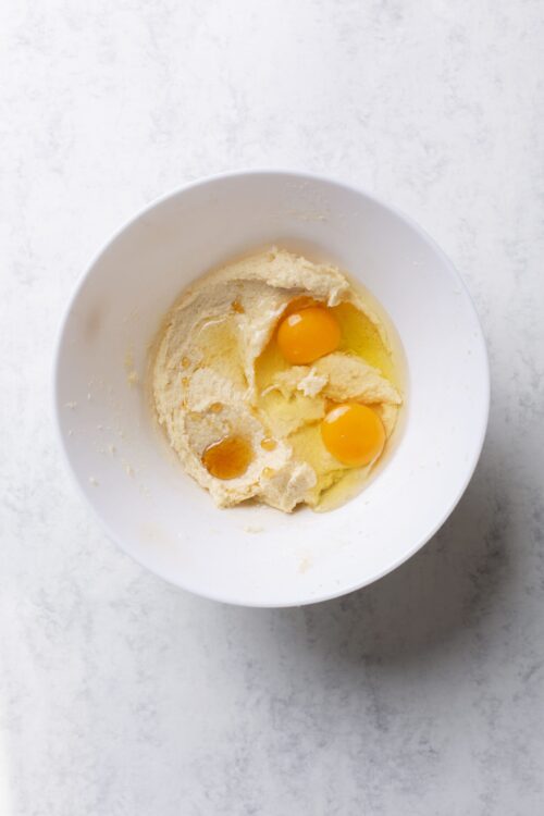 Butter and eggs in a white bowl for baking, baking ingredients, dessert preparation.