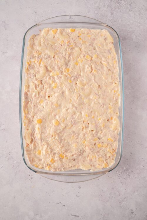 Creamy macaroni and cheese casserole in a glass baking dish.