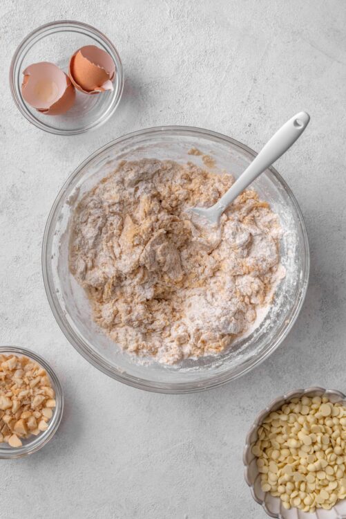 Creamy cookie dough in a glass mixing bowl for baking recipes.