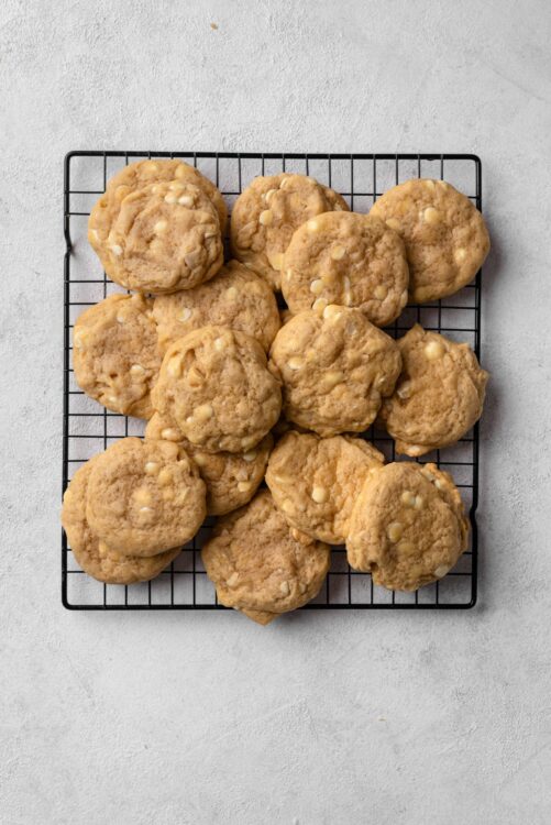Buttery white chocolate macadamia nut cookies on cooling rack, homemade cookie recipe, baked goods from Baked Bree.