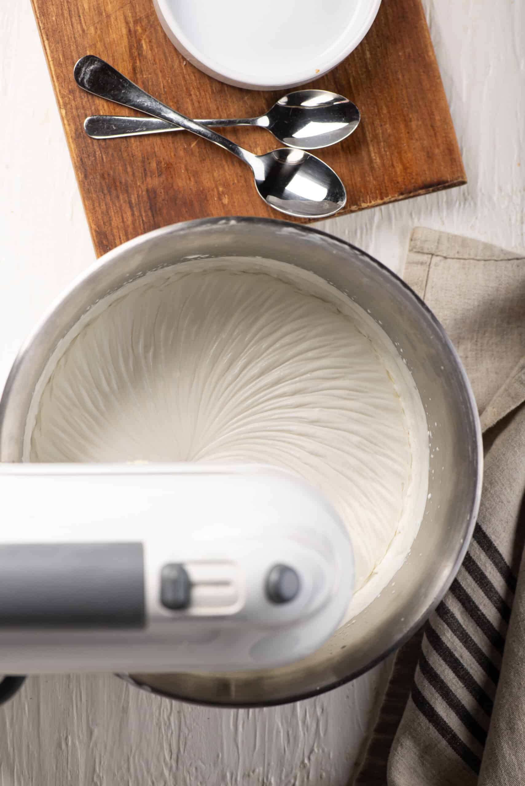 Creamy batter swirling in a stand mixer for baking.