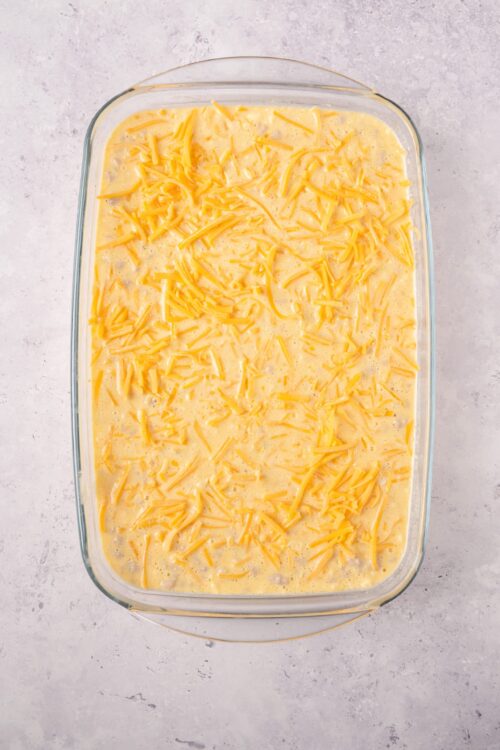 Creamy cheese and egg mixture in glass baking dish, ready for baking.