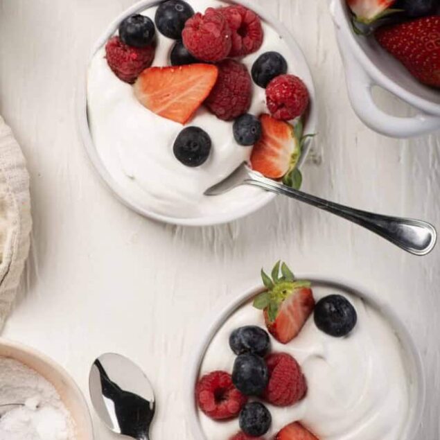 Fresh berry-topped yogurt bowls with strawberries, raspberries, and blueberries.
