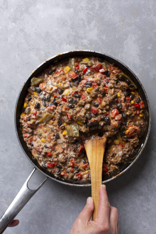 Savory beef and bean chili in a skillet, cooked with vegetables and spices.