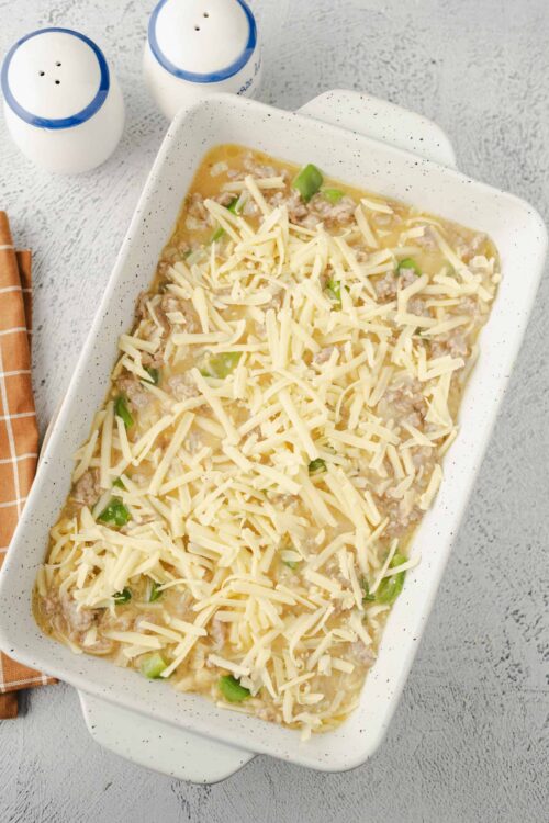 Creamy baked chicken and cheese casserole with green onions, topped with shredded cheese.