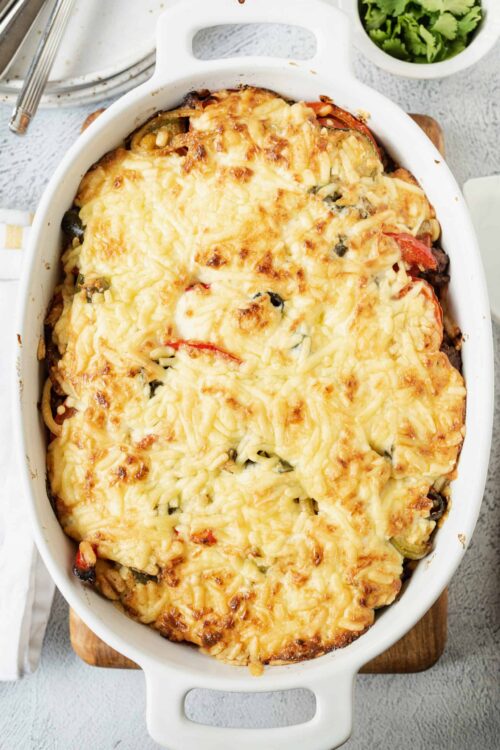 Baked cheesy casserole topped with melted cheese, vegetables, and a golden crust.