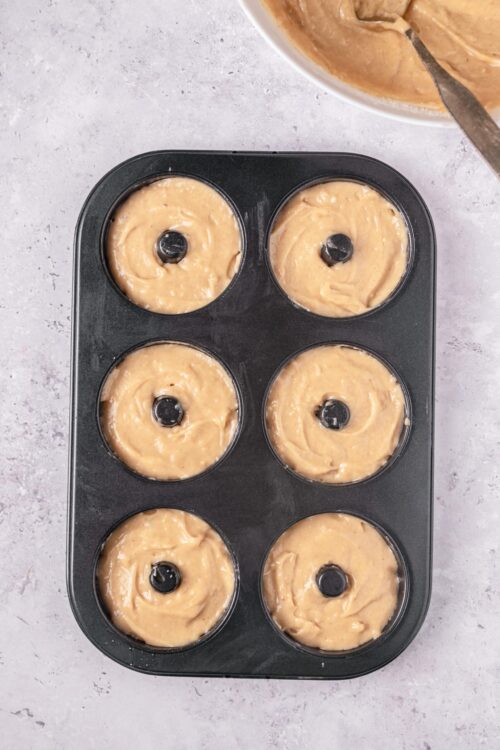 Cream cheese muffin batter in a muffin tin ready to bake, delicious baked good preparation.