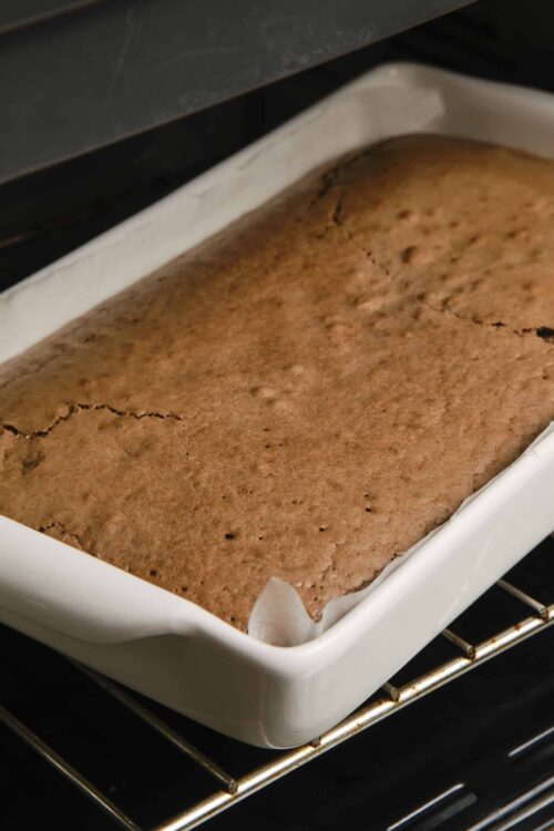 Buttermilk chocolate sheet cake cooling in an oven dish.