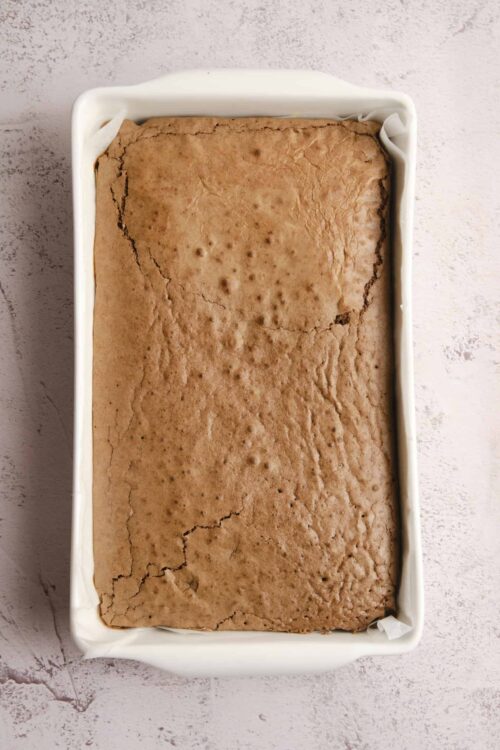 Golden baked blondie in a white baking dish, fresh from the oven.