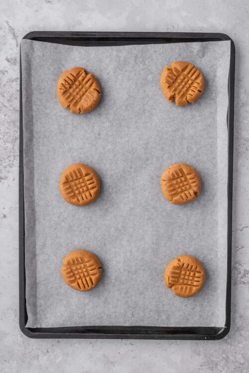 Butter cookies on baking sheet with parchment paper, homemade cookie recipe, baked treats, simple cookies, delicious baked goods.