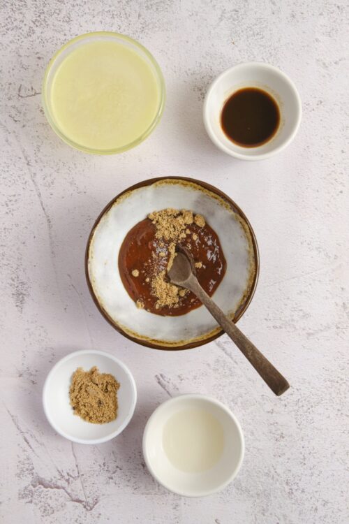 Sweet and savory ingredients for DIY Baked Bree Asian dessert, including brown sugar, soy sauce, and rice wine.