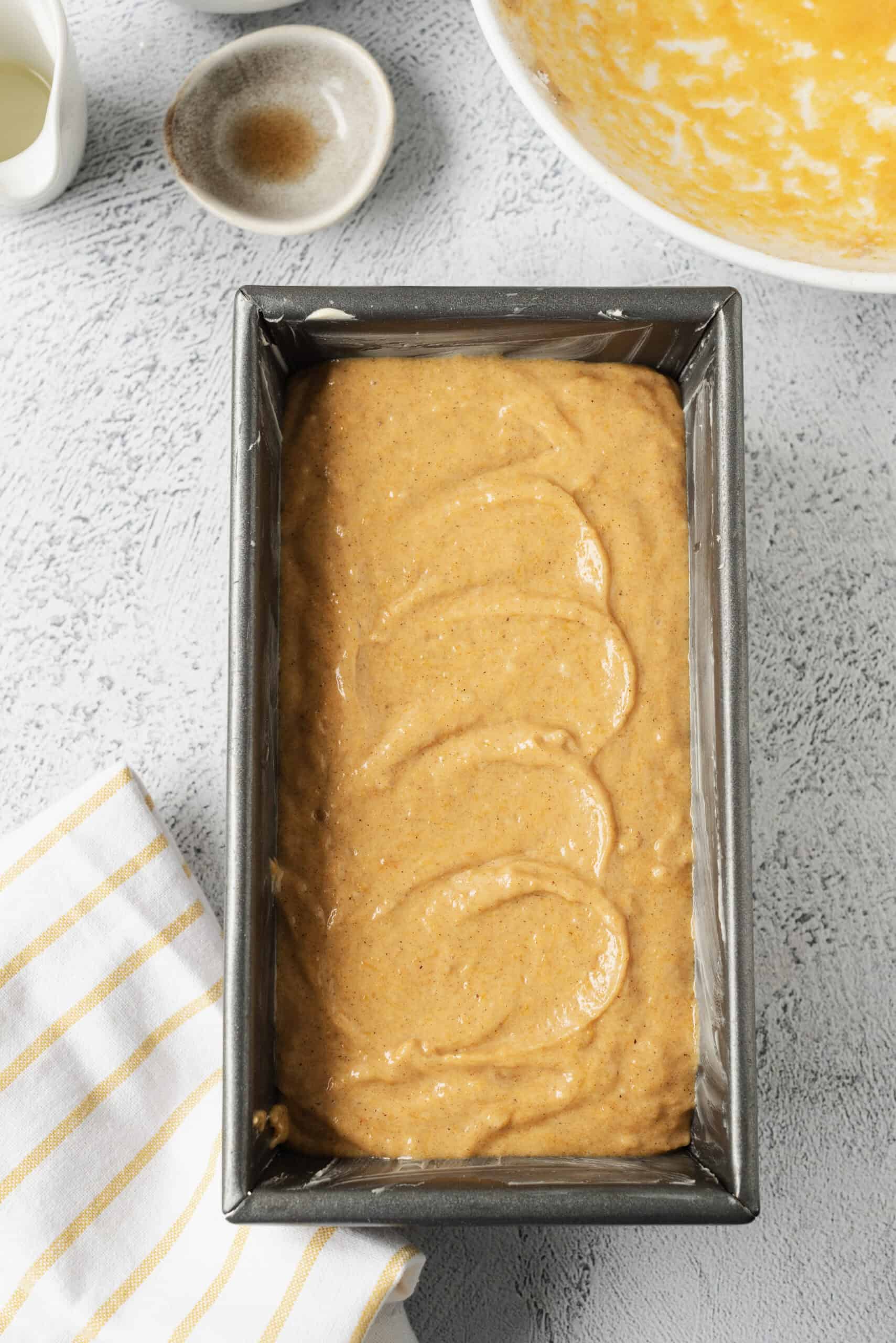 Cream cheese pumpkin bread batter in a loaf pan for baking.