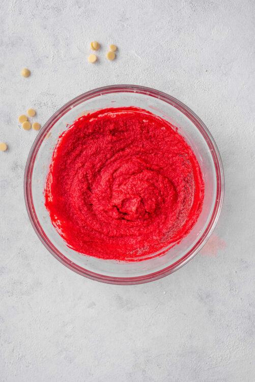 Bright red matcha powder in glass mixing bowl for baking recipes.