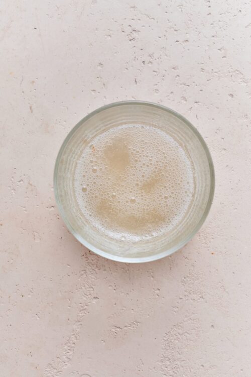 Creamy vanilla milk in a clear glass.