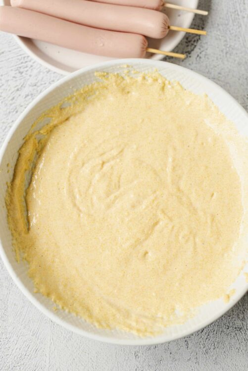 Creamy batter mixture for sausage toad in the hole, ready for baking or cooking.
