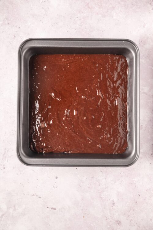 Rich chocolate brownie batter in a baking pan. Perfect for homemade brownies and dessert recipes.