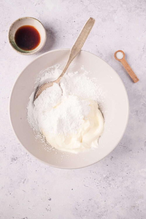 Flour, cream cheese, and soy sauce in a bowl for baking or cooking recipes.