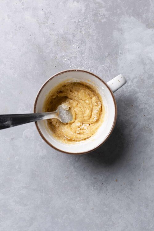 Smooth cookie dough in a mug for baking recipes.