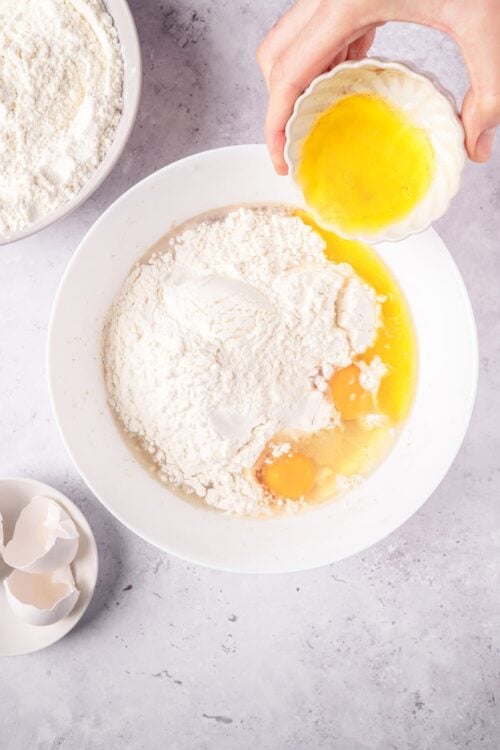 Flour, eggs, and butter being mixed for baking bread or cake recipe.