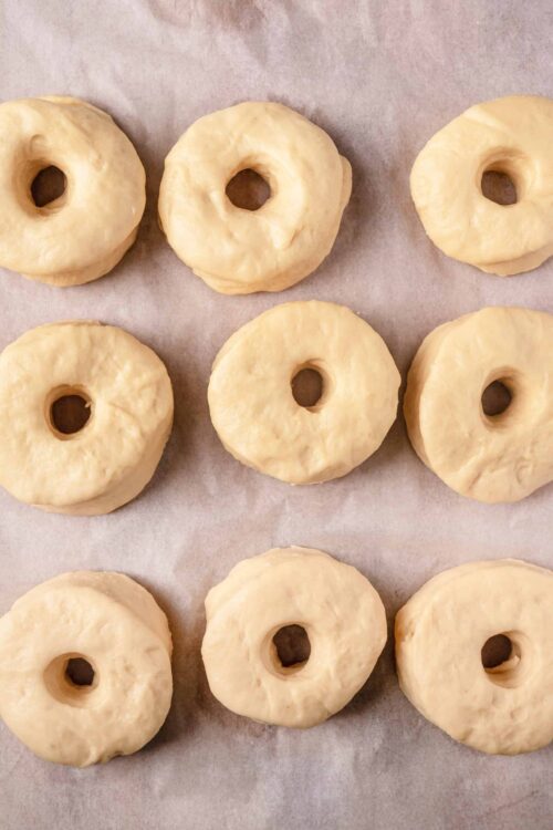 Buttermilk donuts on parchment paper ready to bake.