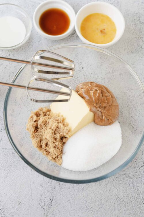 Butter, brown sugar, vanilla extract, eggs, and milk in a mixing bowl for baking recipes.