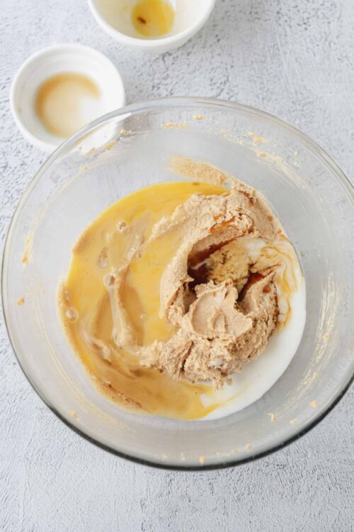 Creamy cookie dough and eggs in mixing bowl for baking recipes.