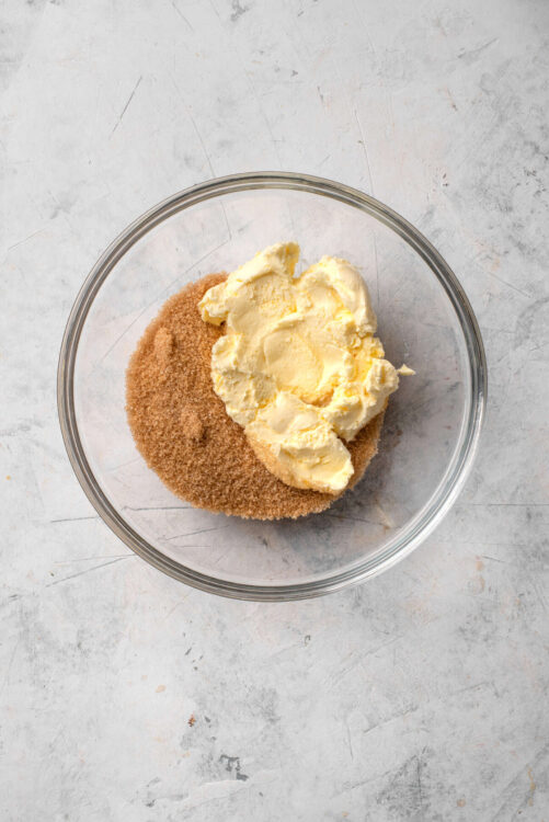 Butter and brown sugar in a glass mixing bowl for baking recipes.