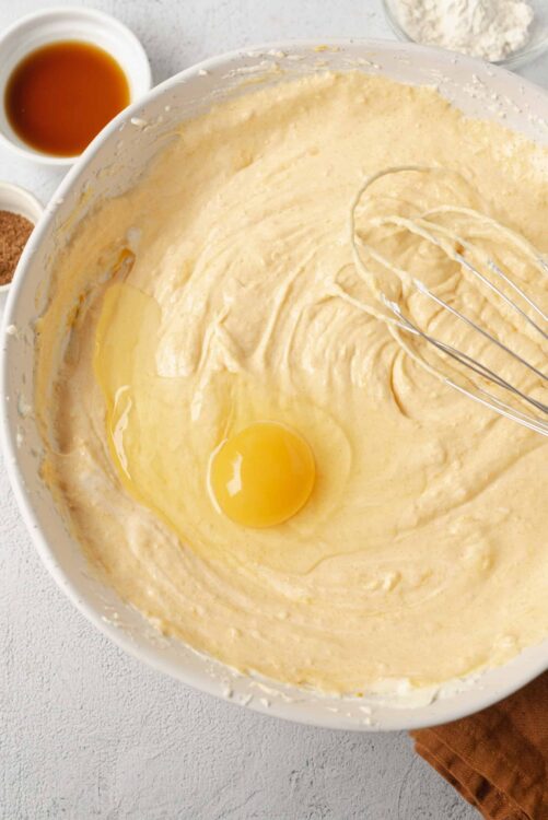 Fluffy cake batter with eggs in a mixing bowl for baking.