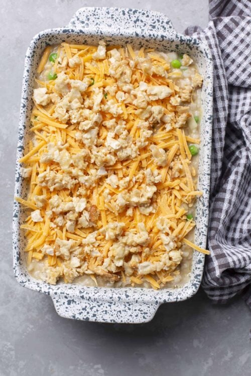 Cheesy chicken casserole baked dish with shredded cheese and toppings.