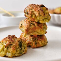 Crab cakes with crispy golden exterior and tender seafood filling on a white serving plate.