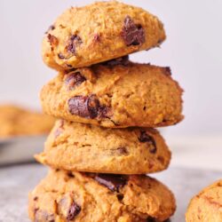 Fudgy chocolate chip cookies stacked on a marble surface. Perfect for baking and dessert recipes.