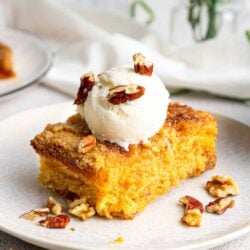 Buttermilk pecan pie with vanilla ice cream and chopped walnuts on top.