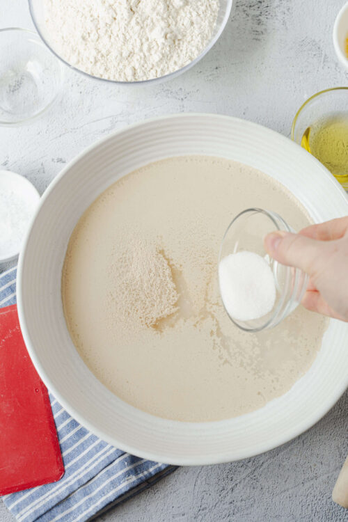 Flour and milk mixture for baking on white bowl.