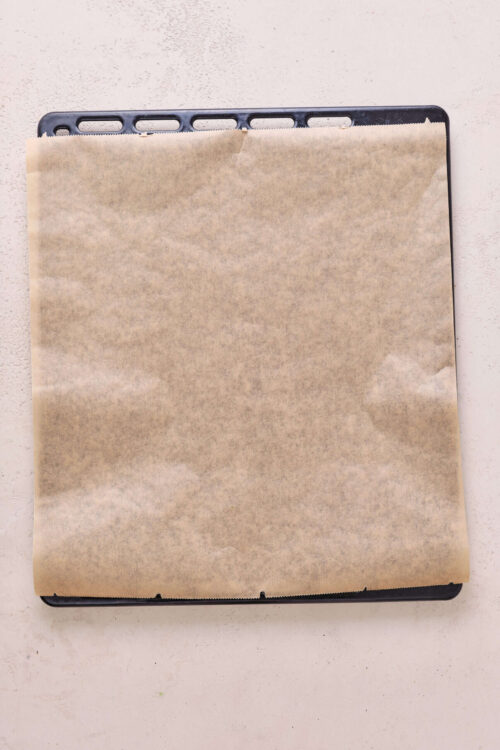 Baked Bree baking sheet with parchment paper ready for baking or roasting.
