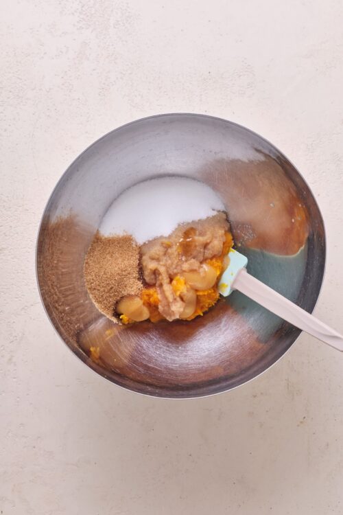 Creamy pumpkin pie filling ingredients in a mixing bowl, ready for baking.