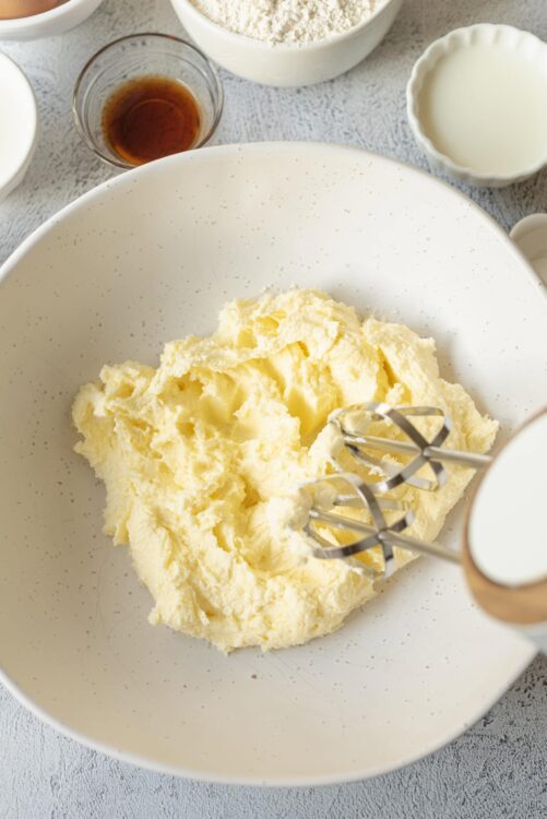 Butter in a mixing bowl with an electric hand mixer ready for baking, close-up baking ingredients, perfect for baking recipes.