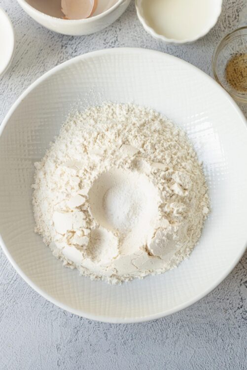 All-purpose flour in a white mixing bowl for baking recipes.