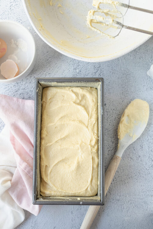Cream butter and sugar cake batter in a loaf pan for fresh baked goods.
