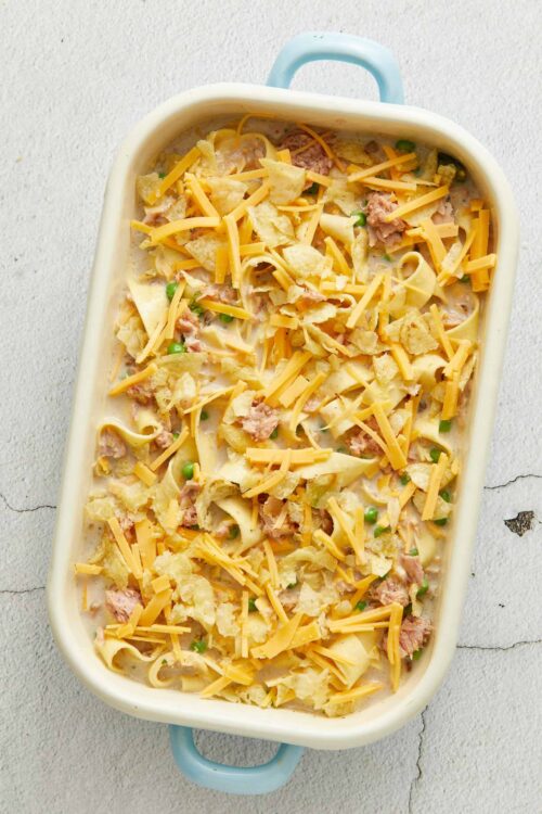 Creamy chicken pot pie casserole with shredded cheese, peas, and crispy topping.