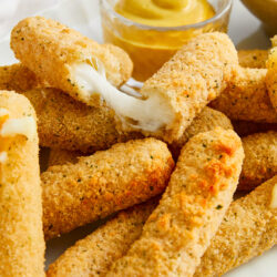 Crispy fried mozzarella sticks with gooey melted cheese, served with creamy dipping sauces.