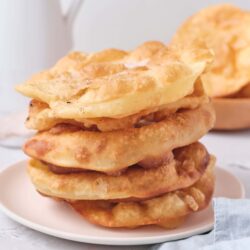 Golden fried bread called Indian frying bread or naan. Traditional Indian homemade fried bread stack with crispy and soft textures.