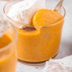 Sweet potato puree with whipped cream in a glass bowl, ready to serve.