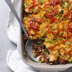 Creamy baked casserole with ground beef, mashed potatoes, and melted cheese topped with green onions.