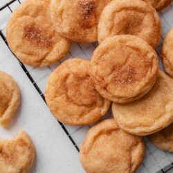 Fluffy homemade cinnamon sugar donuts on cooling rack.