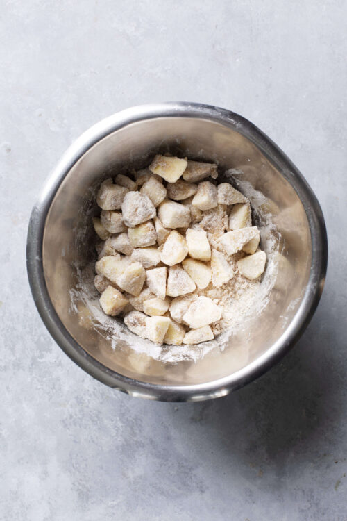 Crust dough chunks in a mixing bowl for homemade baked goods.