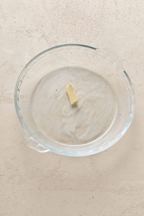 Butter in a glass mixing bowl for baking recipes.