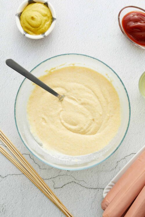 Creamy yellow cake batter in a glass mixing bowl for baking recipes.